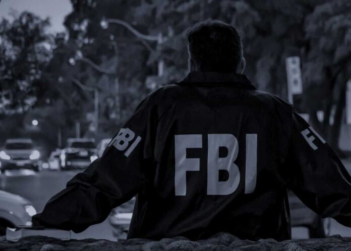 Male,Fbi,Agent,Wearing,Dark,Blue,Coat,With,Fbi,Logo