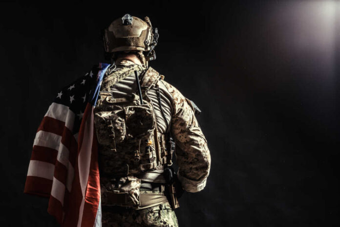 Soldier,Holding,Machine,Gun,With,National,Flag