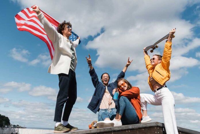 Excited,Asian,Man,Showing,Rock,Signs,Near,Friends,With,Usa