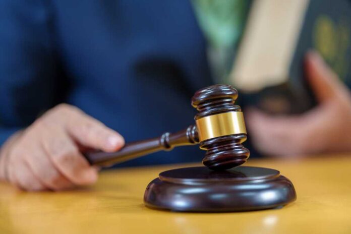 Close,Up,Male,Judge,Hitting,Gavel,Off,A,Block,In