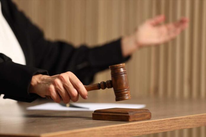 Judge,Striking,Mallet,At,Wooden,Table,Indoors,,Closeup.,Space,For