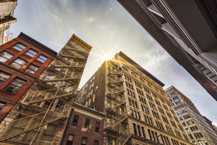 Narrow,Alley,With,Old,Apartment,Buildings,And,Fire,Escapes,On