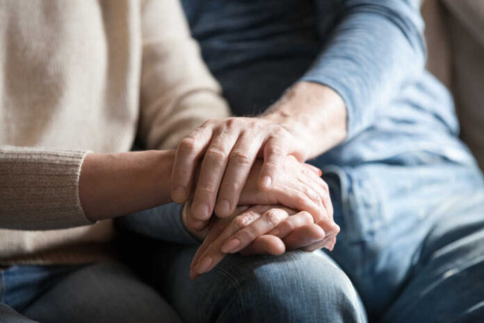Close,Up,View,Of,Mature,Couple,Holding,Hands,,Loving,Caring