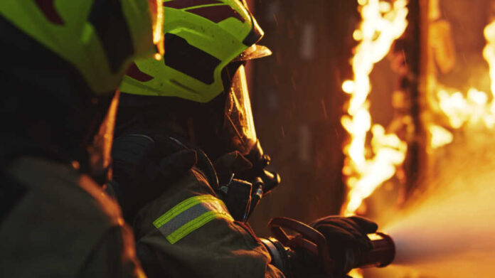 Fireman,Extinguish,Fire,With,The,Hose.,Burning,House,Fire,Drill.