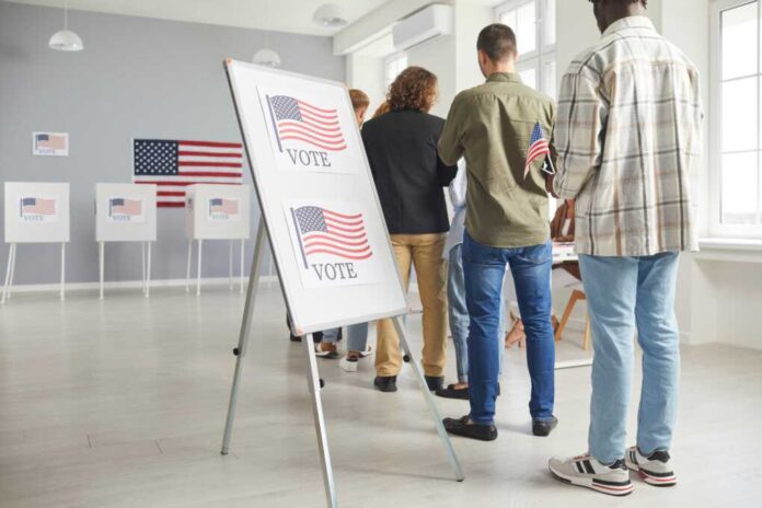Large,Group,Of,Diverse,People,Registering,At,Polling,Station,Holding