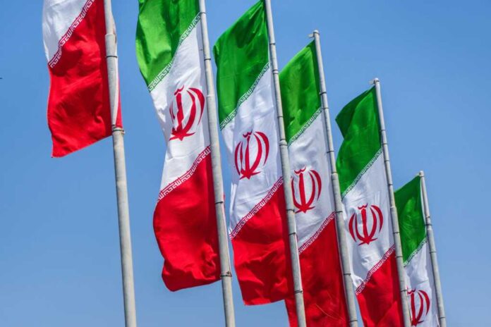 Group,Of,Iran,Flags,Against,Blue,Sunny,Sky,Background