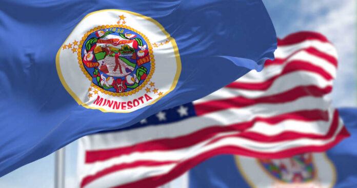 Minnesota state flag in front of American flags