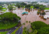 Aerial view of a flooded area with submerged roads and trees