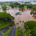 Aerial view of a flooded area with submerged roads and trees