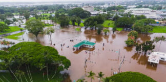 Aerial view of a flooded area with submerged roads and trees