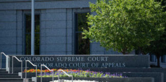 Exterior view of the Colorado Supreme Court building with landscaped flowers