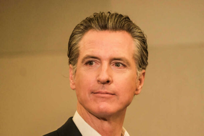 A man in business attire with a serious expression, captured in a medium shot