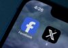 Close-up of smartphone screen displaying Facebook and X app icons