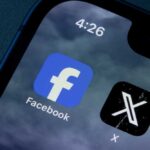 Close-up of smartphone screen displaying Facebook and X app icons