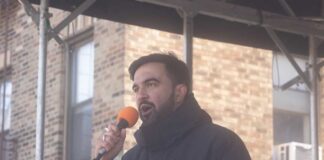 A man speaking into a microphone at an outdoor event