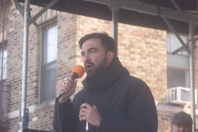 A man speaking into a microphone at an outdoor event