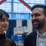 Two individuals engaged in conversation at a voting location
