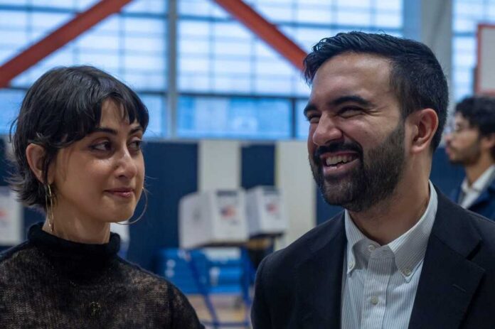 Two individuals engaged in conversation at a voting location