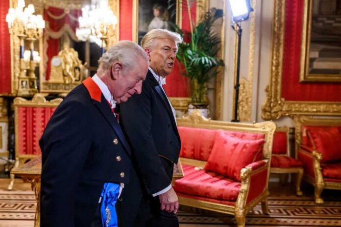 Two men in formal attire walking through a lavishly decorated room
