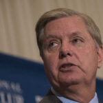 A man speaking at a podium during a conference