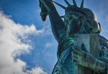 Close-up view of the Statue of Liberty against a blue sky
