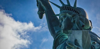 Close-up view of the Statue of Liberty against a blue sky