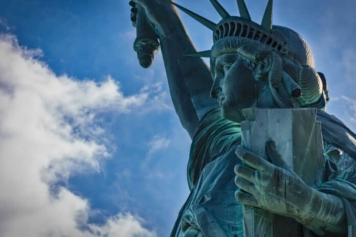 Close-up view of the Statue of Liberty against a blue sky