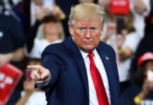 “Narco-Terrorists” Targeted—UN Slams U.S. Actions A man in a blue suit and red tie gestures while speaking at a rally