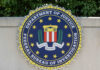 FBI seal featuring the Department of Justice emblem on a wall