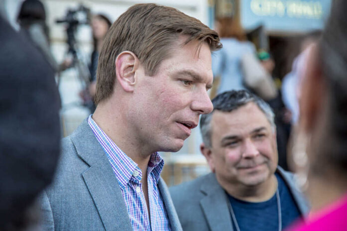 Two men engaged in conversation at an outdoor event