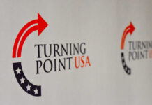 Logo of Turning Point USA displayed on a backdrop