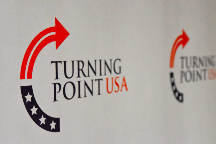 shutterstock_1232509096.jpg Logo of Turning Point USA displayed on a backdrop