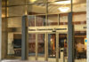 Entrance of the Federal Communications Commission building with glass doors and signage
