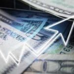 Close-up of U.S. dollar bills with a rising graph overlay