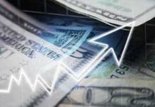 Close-up of U.S. dollar bills with a rising graph overlay