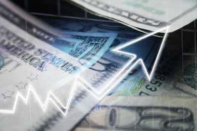 Close-up of U.S. dollar bills with a rising graph overlay