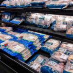 Shelves stocked with various packages of free range chicken