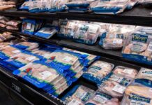 Shelves stocked with various packages of free range chicken