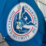 DHS Shutdown Blamed for Trump Attack—Funding Drama Flag of the U.S. Department of Homeland Security displayed on a building