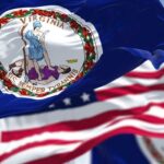 Virginia state flag waving in the foreground with an American flag in the background
