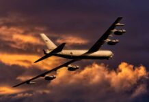 B-52s in Iran: Pentagon’s BOMBSHELL Move! Military aircraft flying against a colorful sunset sky