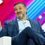 A man in a suit speaking at a conference