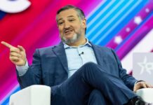 A man in a suit speaking at a conference