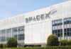 Elon Musk’s Space Gamble: Will Main Street Pay? Exterior view of the SpaceX building with a prominent logo