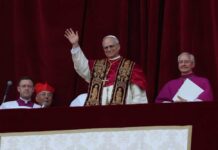 Pope waving from a balcony during a public address