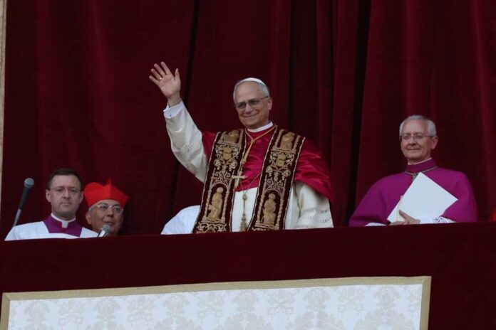 Pope waving from a balcony during a public address