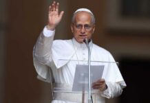 Religious leader giving a speech outdoors with a raised hand