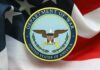 Pentagon Turmoil: Leadership Rift Exposed! Emblem of the Department of War on a background of the American flag