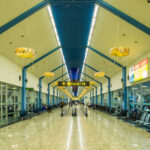 Interior view of an airport terminal with seating and directional signs