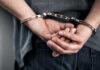 Hidden Law Triggers Life Sentence—What’s Missing? Hands cuffed behind the back, indicating arrest